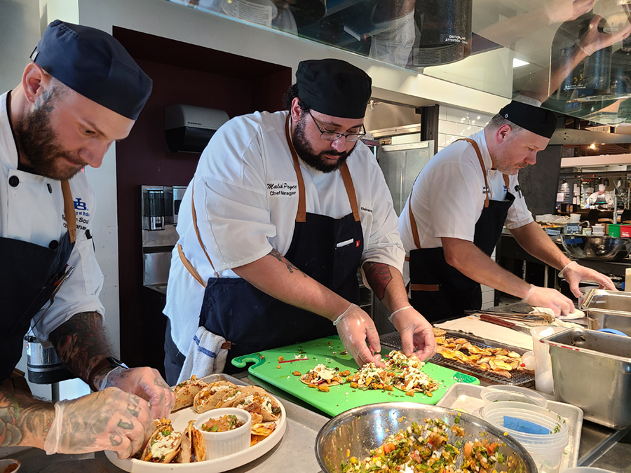 Three of the chefs preparing the meal