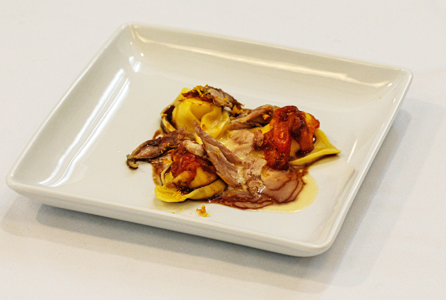 Appetizer: Confit Cornish Game Hen Tortellini. Meyer lemon stuffed spaghetti squash tortellini, blood orange butter cream sauce, tomato compote and balsamic reduction