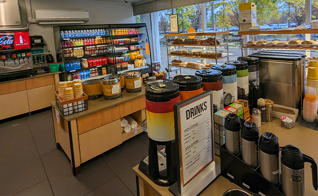 Au Bon Pain's self-serve areas including Grab-n-Go, hot bar, coffees, and bakery items