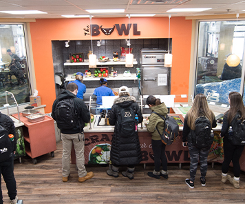 Students making their own bowls from the salad bar