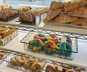 Close up shot of various bakery items on the shelves near the windows