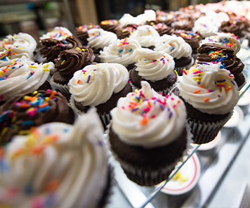 Chocolate cupcakes with chocolate or vanilla frosting, topped with sprinkles