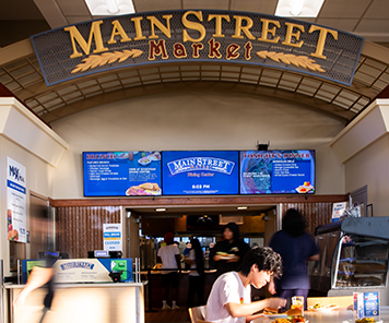 Main Street Market sign with our digital signage showing Breakfast options and 