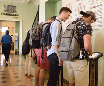 Students ordering on the TAPAS ordering kiosk in front of Harriman Café