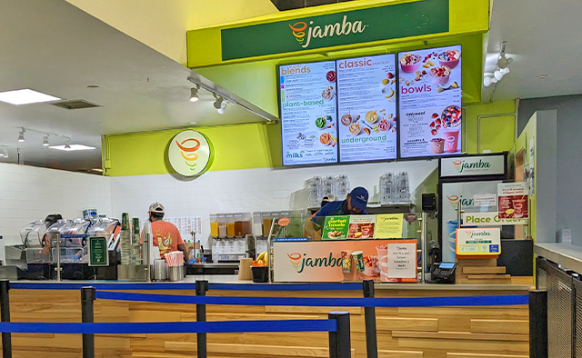 Jamba counter in the Student Union, associates hard at work, with digital menuboards on the walls