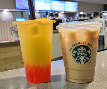 Mango Green Tea Bubble Tea with strawberry popping boba, and a latte from the Perks tall counter overlooking the digital menuboards