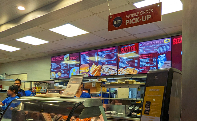 Mobile order pick up window at the Sizzles counter, overlooking the digital menuboards