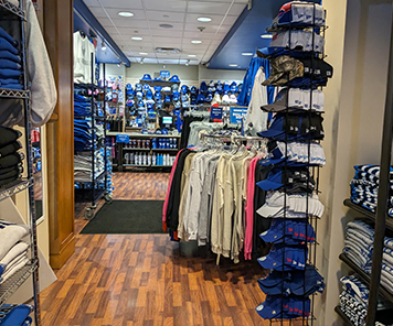 A view down the aisles of clothing for sale inside the Campus Tees store