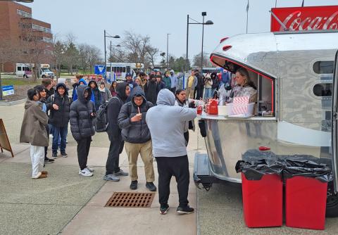 Coca Cola ambassadors serving guests from the Coca Cola Throwback car