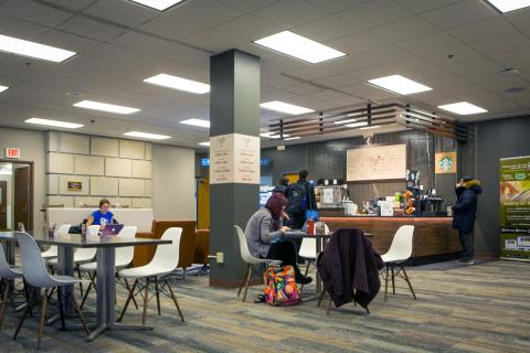 Students eating at tables and ordering at Whispers Café at Abbott Library. Photo by Douglas Levere.