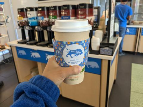 Coffee cup with a Bulls on the Run coffee sleeve