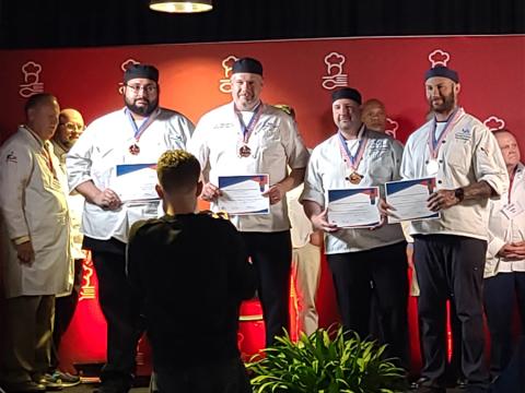 The four chefs on stage presenting their awards