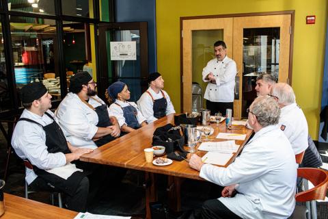 Chefs Michael Gorham, Malik Pryce, Kaprishia Covington and Ryan Rodenhaus at a table with American Culinary Foundation folks