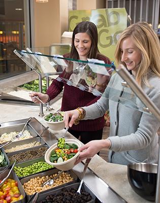 Employees enjoying building their own salad bowl at The Bowl in Ellicott Food Court (EFC)