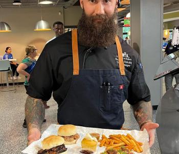Chef Brendan showcasing his featured dish at Crossroads Culinary Center (C3).