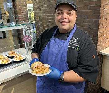 Chef Jason showcasing his featured dish at Governors Dining Center.