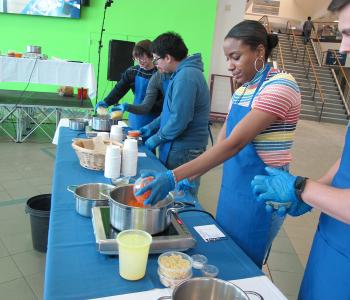 Students participating in Chef Neal Plazio's cooking lesson in the Student Union on North Campus