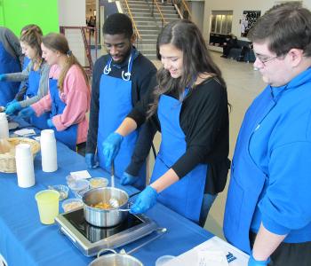 Students participating in Chef Neal Plazio's cooking lesson in the Student Union on North Campus