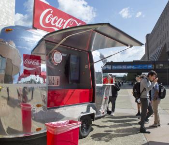 Coca-Cola Throwback truck from the side. Employees serving free Coke floats to students.