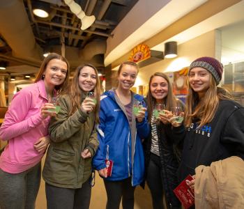 Students enjoying their Clue branded glasses with the featured drink of the evening
