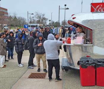 Coca Cola ambassadors serving guests from the Coca Cola Throwback car