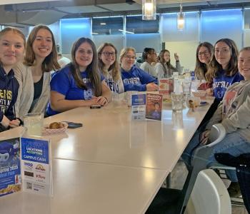 Ten students enjoying a meal together at Crossroads (C3)