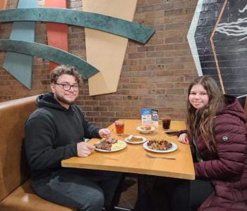 Two students eating pizza together at Governors Dining Center
