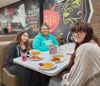 Three students eating a holiday meal together at Governors Dining Center