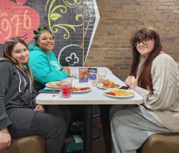 Three students eating a holiday meal together at Governors Dining Center