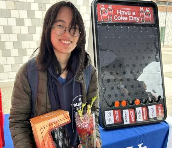 Student smiling showing off their Coca Cola prize