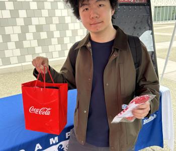 Student showing off their Coca Cola prize