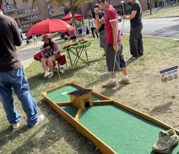 Students playing mini golf