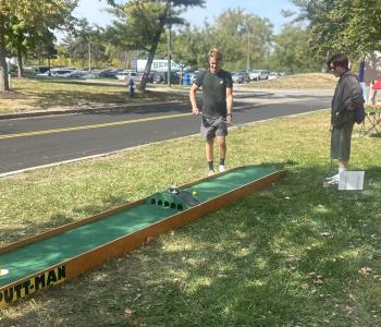 Students playing mini golf