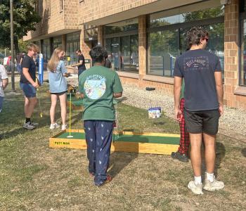 Students playing mini golf