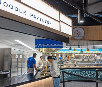 Student picking up their order from Noodle Pavilion. Photo by Onion Studio.