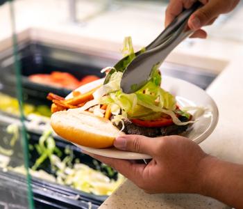 A burger being created at the burger station of Goodyear Dining Center. Photo by Meredith Forrest Kulwicki.