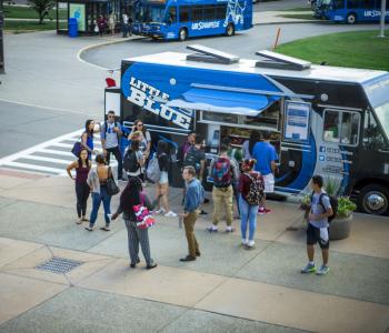 Students in line to order from Little Blue food truck at Lee Loop on North Campus. Photo by Douglas Levere.