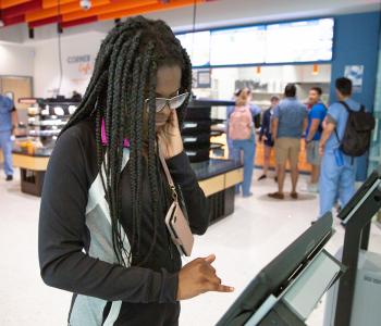 A student deciding what to choose on the Corner Cafe kiosk. Photo by Meredith Forrest Kulwicki.