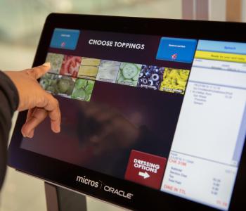 A customer picking toppings on the Corner Café kiosk. Photo by Meredith Forrest Kulwicki.