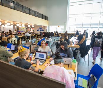People gather to study, eat, and socialize at One World Café in Norton Hall. Photo by Douglas Levere.
