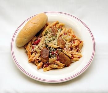 Penne pasta with Italian sausage , peppers and onions, and red sauce, topped with parmesan cheese and served with a breadstick.