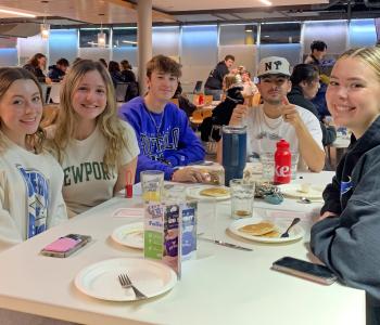 Students seated enjoying pancakes and sausage at Crossroads Culinary Center (C3)