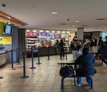 Sizzles is in between Guac & Roll and Wrap it Up in Ellicott Food Court. There is plenty of seating in front of all three locations.