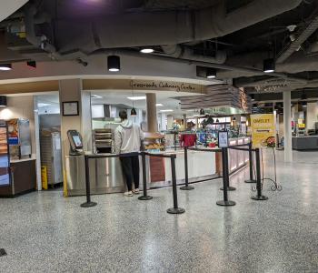 Oreganos pickup station at C3 with "Crossroads Culinary Center" signage above.