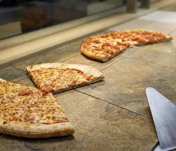 Whole cheese and pepperoni pizzas hot and ready to be served.