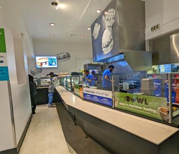 The pickup area of Harriman Café where associates are preparing orders behind the counter.