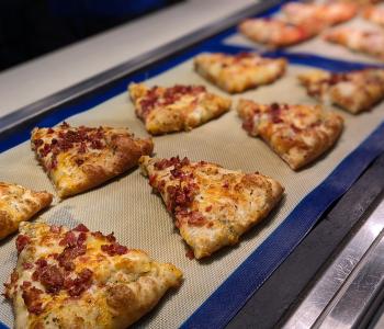 Bacon topped pizza slices served at the Mangia station at Governors Dining Center.