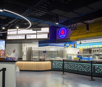 Noodle Pavilion and Pan Asia are at the left side of One World Café near the registers.